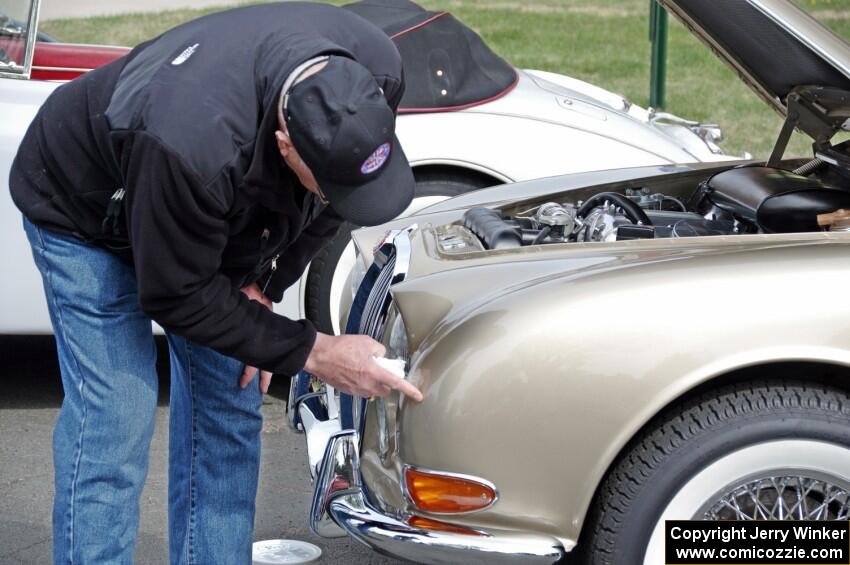 Dwight McCullough does last minute detailing on a Jaguar.