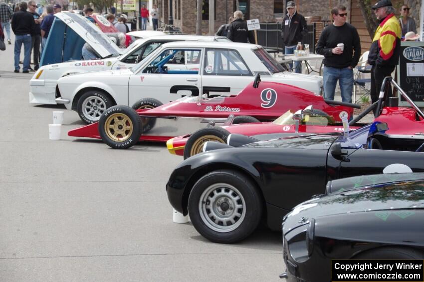 Vintage racing cars lined up on the streets of Osseo.