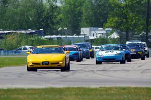 The Spec Miata and smaller production class field comes into turn 12 on the pace lap.