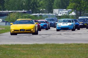 The Spec Miata and smaller production class field comes into turn 12 on the pace lap.