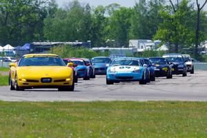 The Spec Miata and smaller production class field comes into turn 12 on the pace lap.