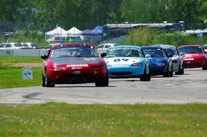 Lon Blaser's STL Mazda Miata leads the pack.