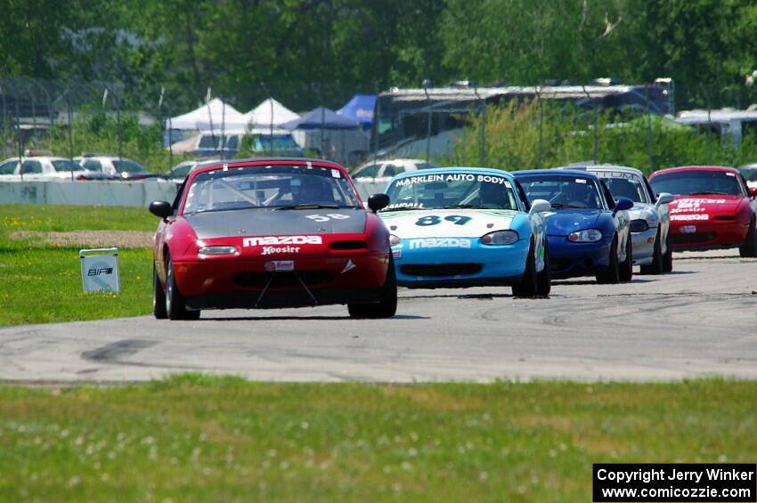 Lon Blaser's STL Mazda Miata leads the pack.