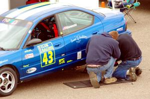 John Glowaski's ITA Dodge Neon ACR gets repairs in the paddock.