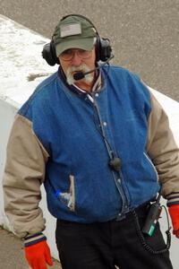 The pit marshal lines cars up.