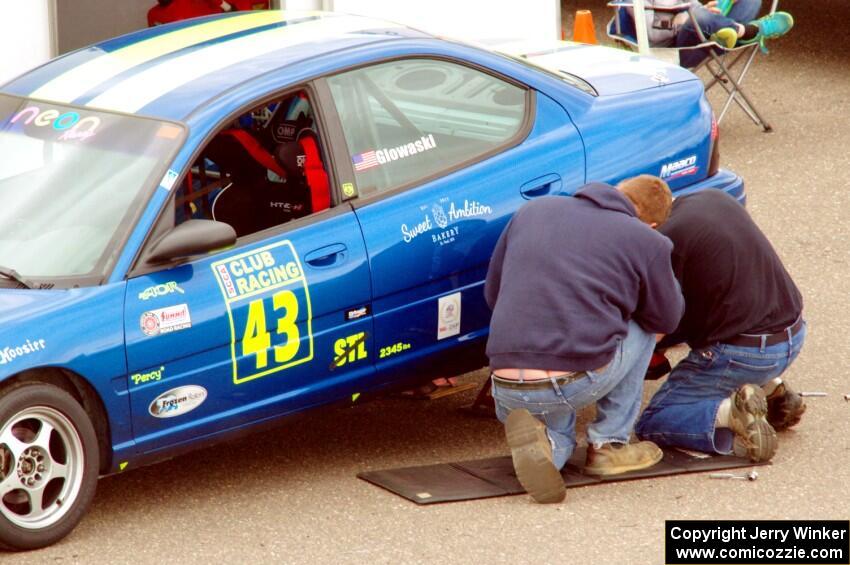 John Glowaski's ITA Dodge Neon ACR gets repairs in the paddock.