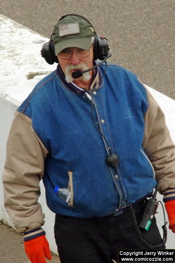 The pit marshal lines cars up.