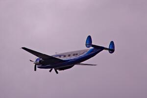 An Howard N500LN flies over thee racetrack.