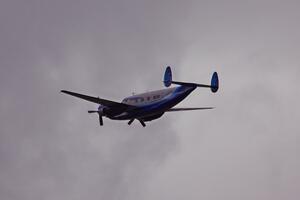 An Howard N500LN flies over thee racetrack.