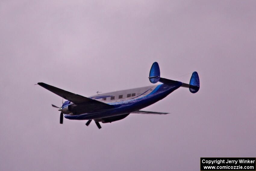 An Howard N500LN flies over thee racetrack.