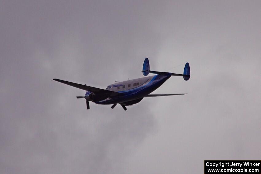 An Howard N500LN flies over thee racetrack.