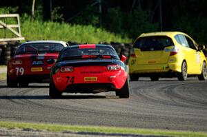 Spencer Patterson's and Matt Fassnacht's Mazda MX-5 Cups chase Jasper Drengler's Honda Fit