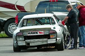 Errora Olds Aurora is in the paddock early on for repairs.