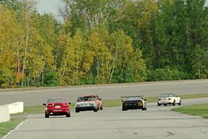 Five cars head down the front straight into turn 1.