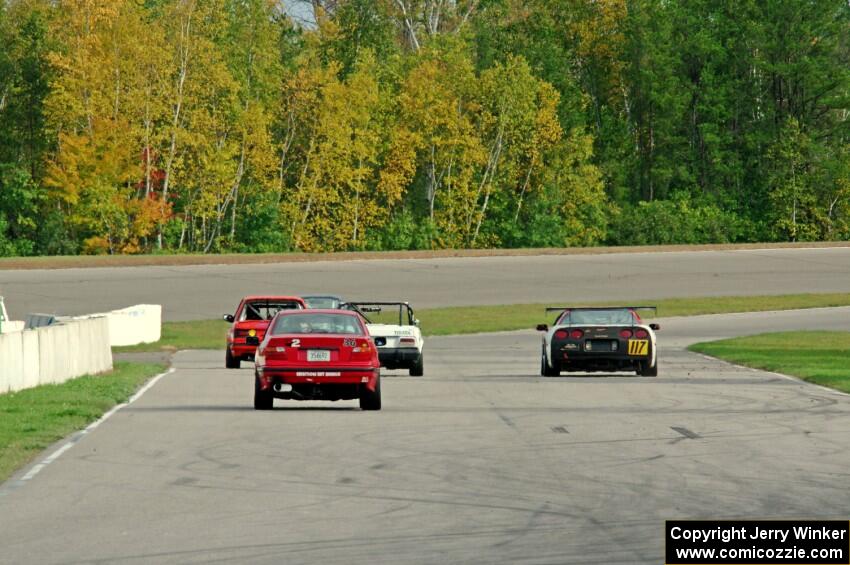 Five cars head down the front straight into turn 1.