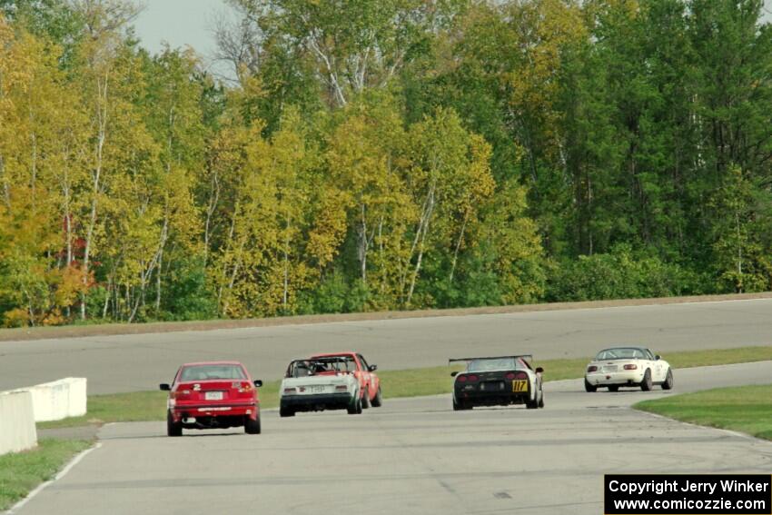 Five cars head down the front straight into turn 1.