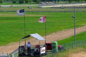 The back half of the field catches up to the front on the pace lap, while start/finish is ready.