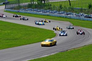 The field streams into turns ten and eleven on the pace lap.