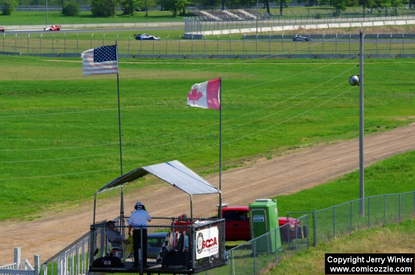 The back half of the field catches up to the front on the pace lap, while start/finish is ready.