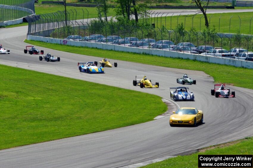 The field streams into turns ten and eleven on the pace lap.