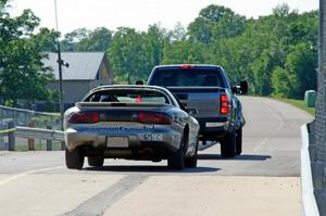 IFW Motorsport Pontiac Firebird is towed back to the paddock.