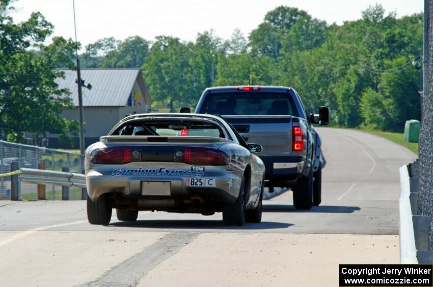 IFW Motorsport Pontiac Firebird is towed back to the paddock.