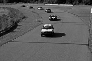 Six cars head through turn 9 before the bridge.