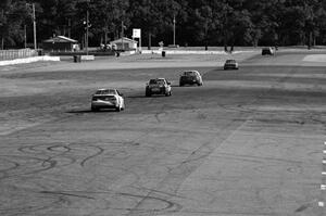 Five cars head down the Kinnard Straight.