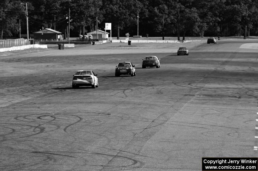 Five cars head down the Kinnard Straight.