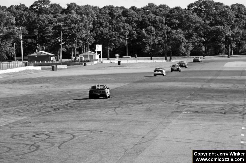 Five cars head down the Kinnard Straight.