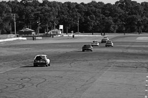 Six cars head down the Kinnard Straight.