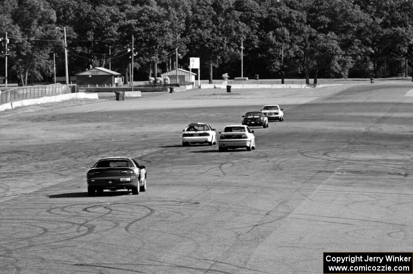 Five cars head down the Kinnard Straight.
