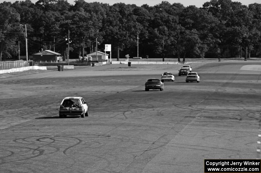 Six cars head down the Kinnard Straight.