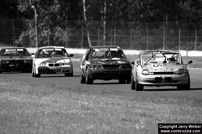 Four cars head into turn 4.