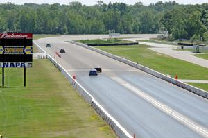 Four cars head down the front straight.