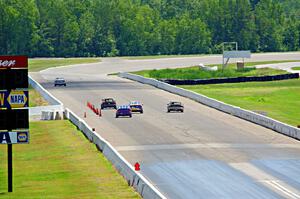 Five cars head down the front straight.