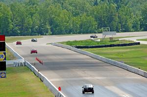 Five cars head down the front straight and into turn one.