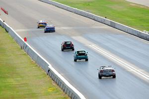 Five cars head down the front straight.