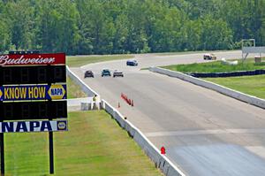 Five cars head down the front straight and into turn one.