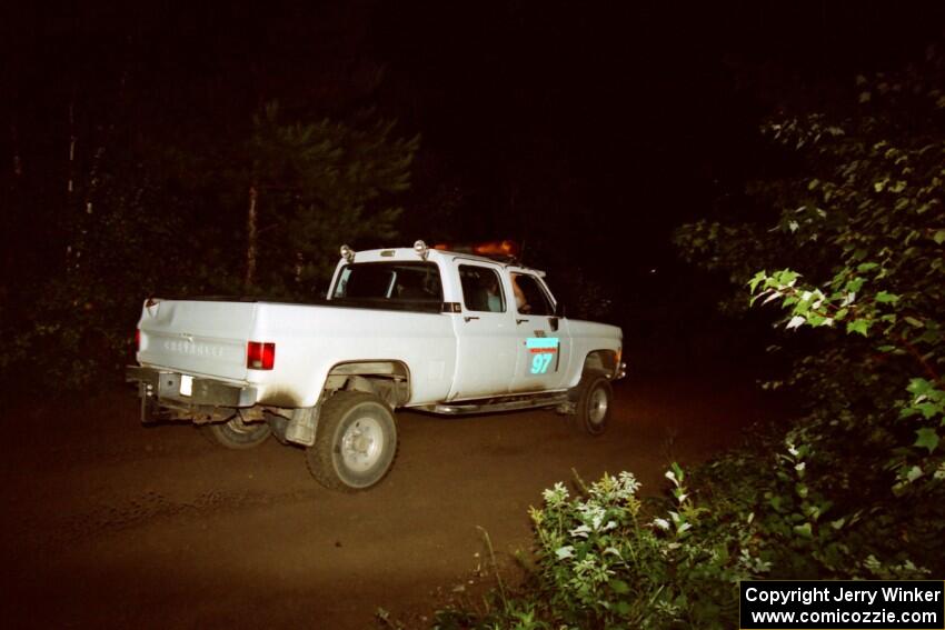 A sweep vehicle drives out of a 90-right on SS2 (Stump Lake).