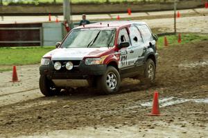 Greg Pachman / Ray Summers Ford Escape slops through the mud on SS7 (Speedway Shenanigans).