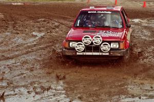 Gary Starr / Bill Tifft Dodge Omni GLH Turbo slops through the mud on SS7 (Speedway Shenanigans).