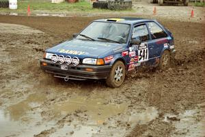 Darek Bosek / Piotr Modrzejewski Mazda 323GTX slops through the mud on SS7 (Speedway Shenanigans).