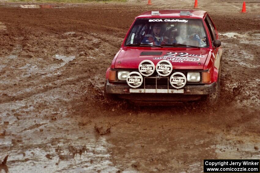 Gary Starr / Bill Tifft Dodge Omni GLH Turbo slops through the mud on SS7 (Speedway Shenanigans).