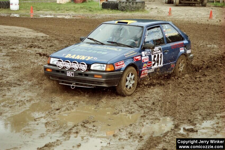 Darek Bosek / Piotr Modrzejewski Mazda 323GTX slops through the mud on SS7 (Speedway Shenanigans).