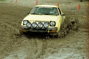 Scott Justus / Sumit Panjabi Mazda RX-7 slops through the mud on SS7 (Speedway Shenanigans).