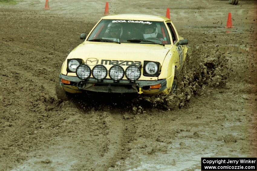 Scott Justus / Sumit Panjabi Mazda RX-7 slops through the mud on SS7 (Speedway Shenanigans).