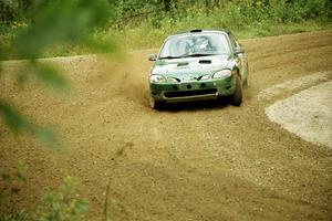 Tad Ohtake / Martin Dapot Ford Escort ZX2 at the spectator point on SS9 (The Spurs).