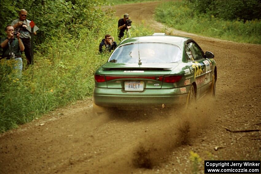 Tad Ohtake / Martin Dapot Ford Escort ZX2 at the spectator point on SS9 (The Spurs).