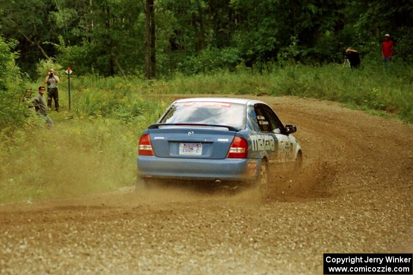 Eric Burmeister / Eric Adams Mazda Protege' MP3 at the spectator point on SS9 (The Spurs).